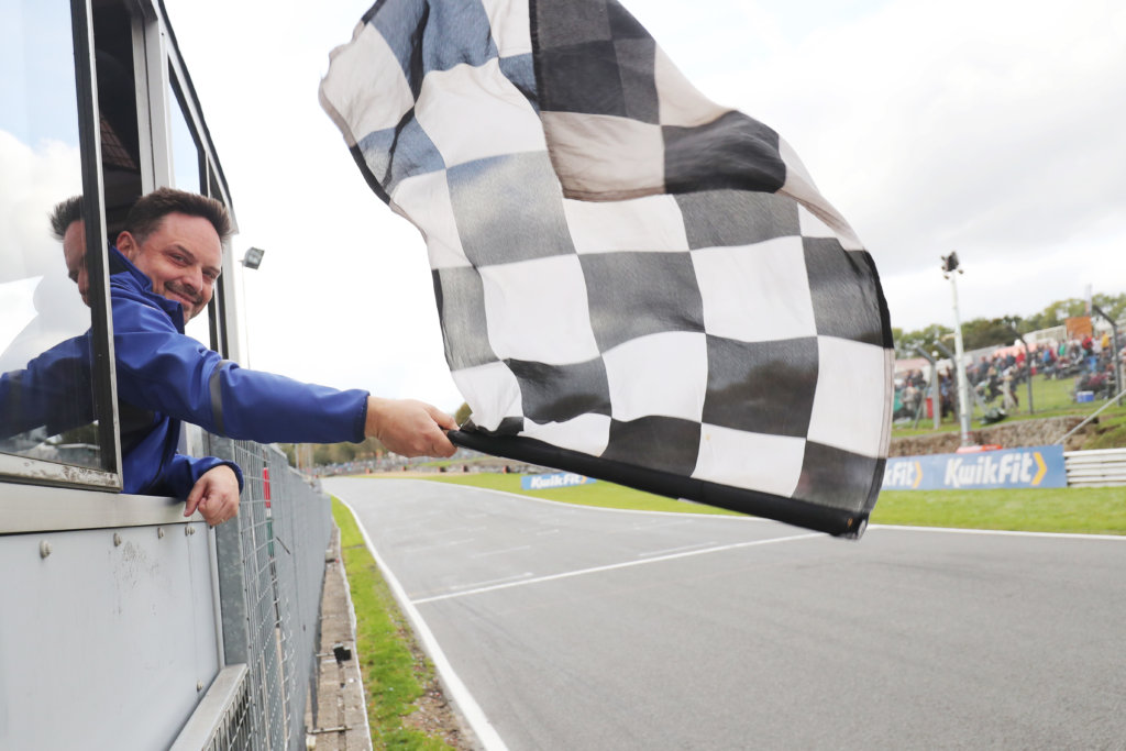 Sam Roach waving the Chquered Flag on the final F4 race